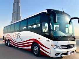 Exterior of a luxury bus featuring the AJ EPIC branding in Dubai.